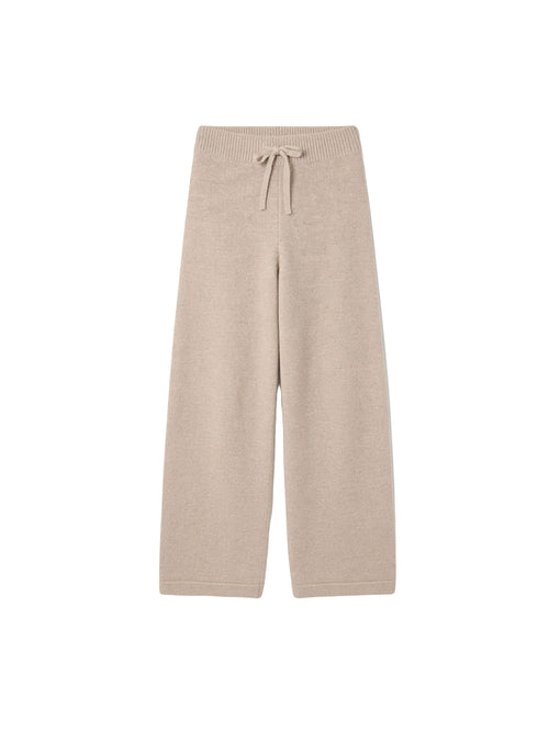 Бежеві вʼязані штани Merin із 100% мериносу на білому фоні 